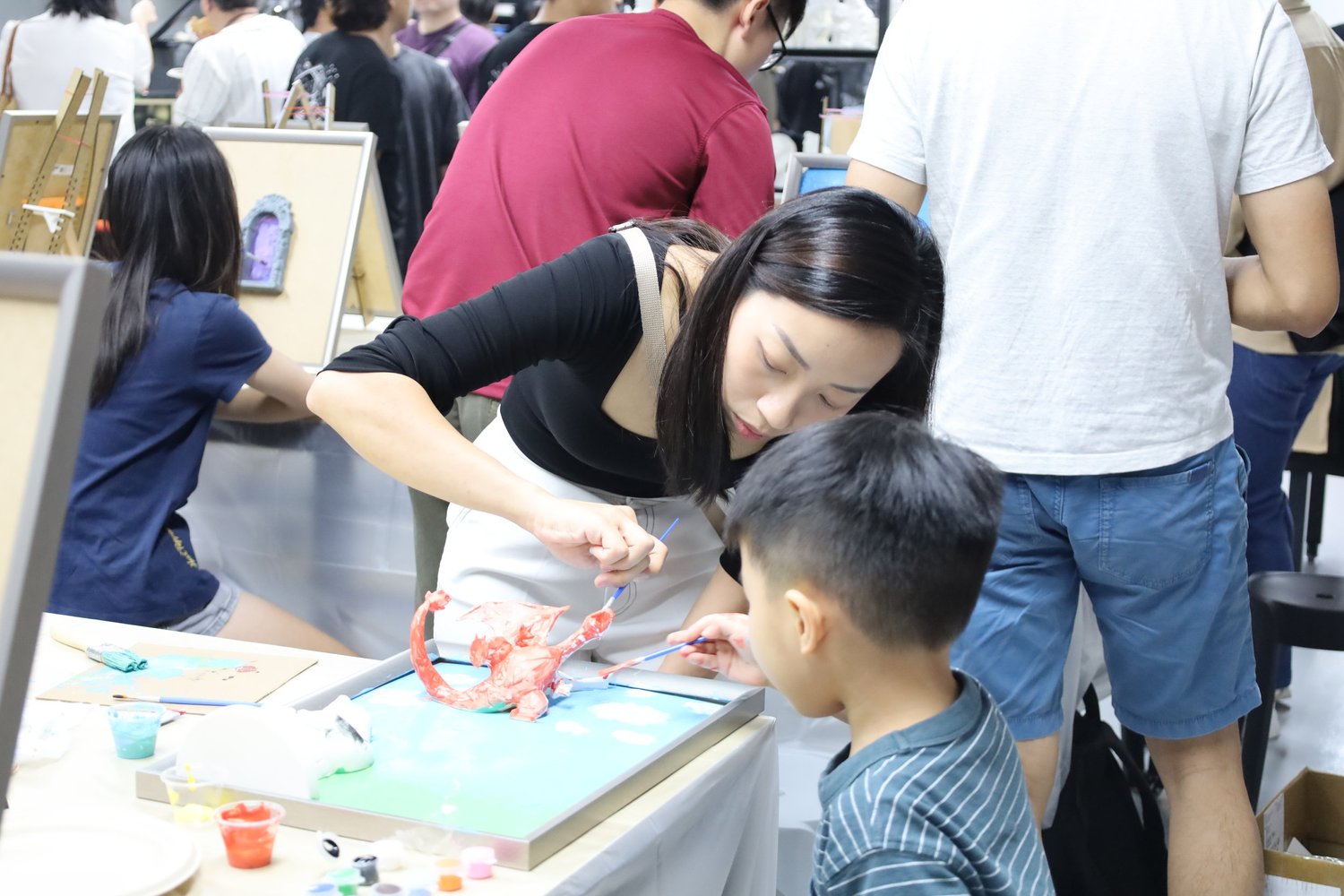 Two friends painting 3D canvases indoors in Singapore